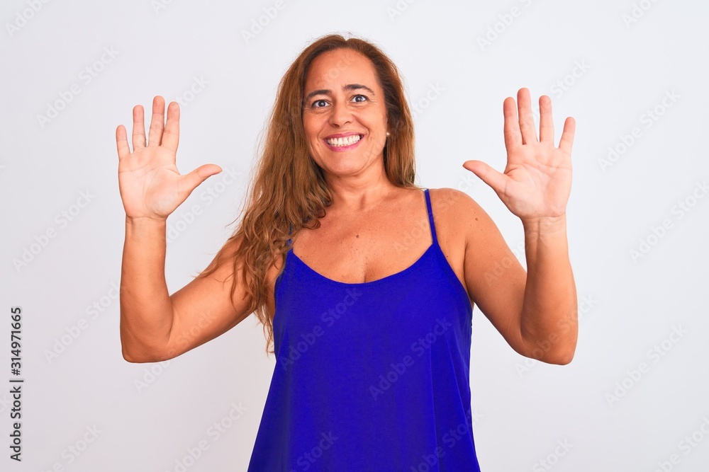 Middle age mature woman standing over white isolated background showing and pointing up with fingers number ten while smiling confident and happy. Middle age mature woman standing over white isolated background showing and pointing up with fingers number ten while smiling confident and happy.