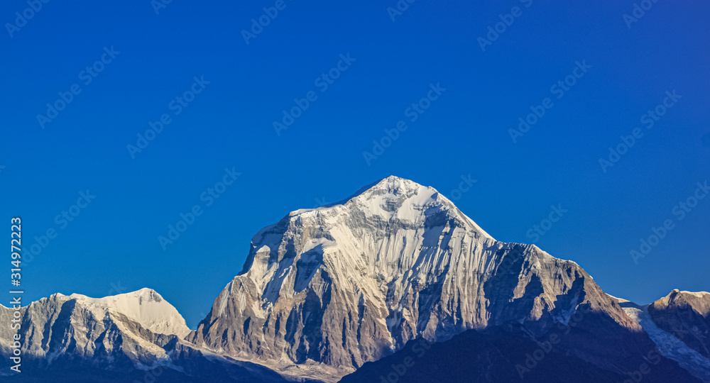 Fototapeta premium Snow-covered Mountain With Blue Sky, Cloud and Fog