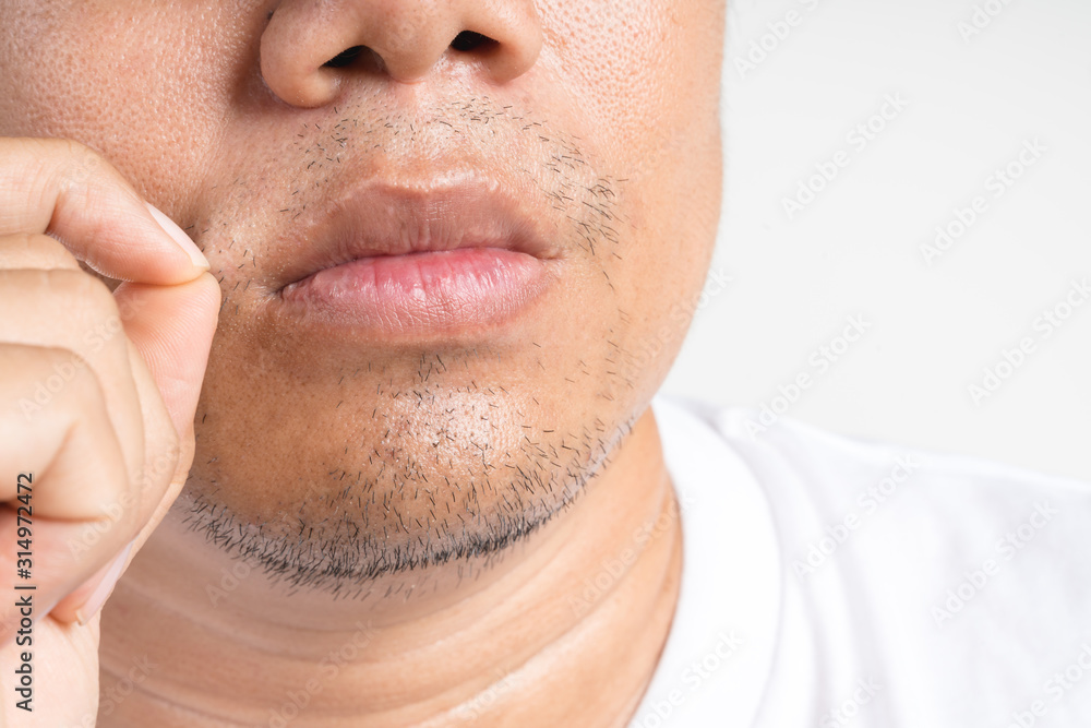 © bonnontawat - Asian man touch and picking new short beard and mustache © bonnontawat - Asian man touch and picking new short beard and mustache