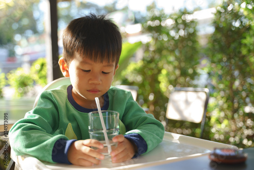 3 year old asian kid drinking water