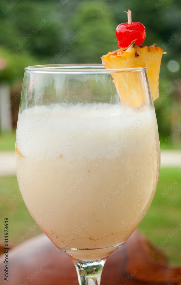 Drink prepared with alcohol, served outdoors, called pina colada, the base  is pina and alcohol in Guatemala, Central America. Stock Photo | Adobe Stock