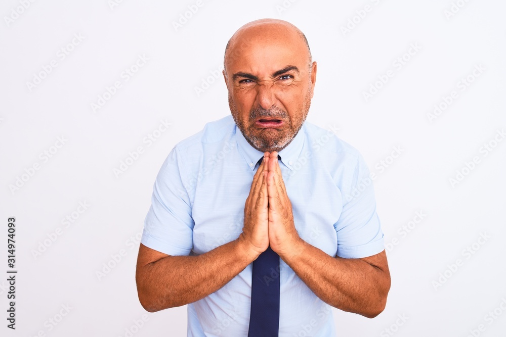 Middle age businessman wearing tie standing over isolated white background begging and praying with hands together with hope expression on face very emotional and worried. Asking for forgiveness Middle age businessman wearing tie standing over isolated white background begging and praying with hands together with hope expression on face very emotional and worried. Asking for forgiveness