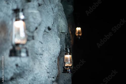 Oil lamp hanging on the cave stone wall