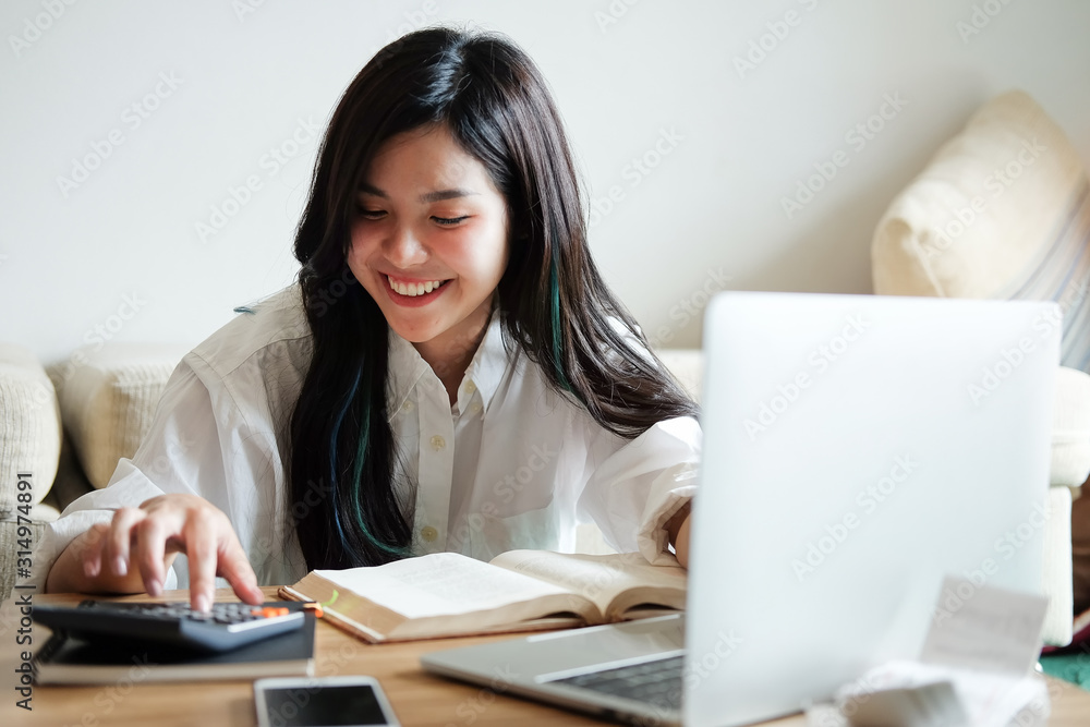 Business working in home living room enjoying sunny morning on the day with documents and laptop people Consulting and business planning. Business working in home living room enjoying sunny morning on the day with documents and laptop people Consulting and business planning.