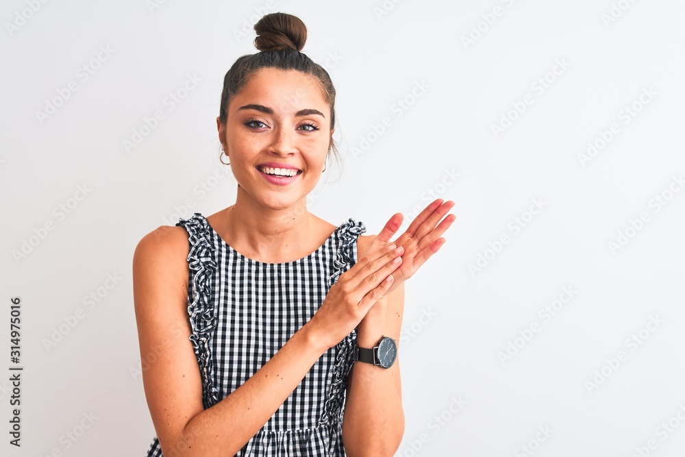 Beautiful woman with bun wearing casual dresss standing over isolated white background clapping and applauding happy and joyful, smiling proud hands together Beautiful woman with bun wearing casual dresss standing over isolated white background clapping and applauding happy and joyful, smiling proud hands together