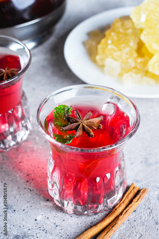 Oriental berry red tea with spices on wooden table background Oriental berry red tea with spices on wooden table background