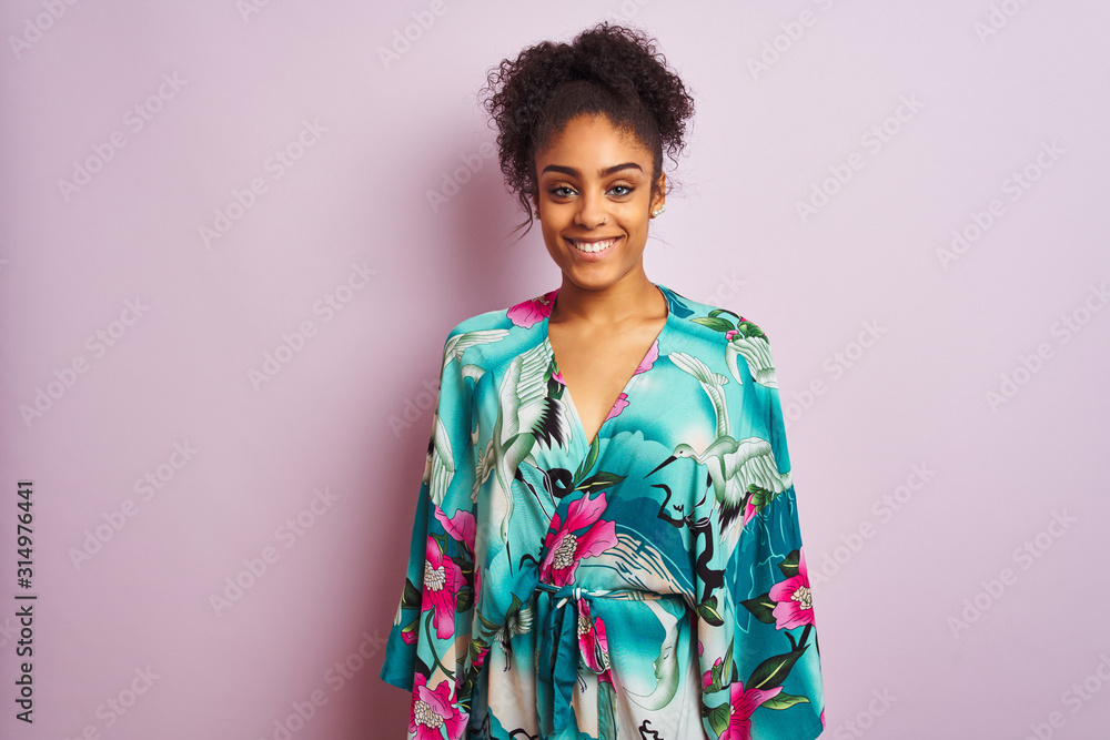Young beautiful african american woman standing wearing elegant colorful caftan Young beautiful african american woman standing wearing elegant colorful caftan