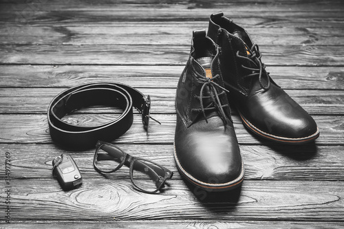 Set of male accessories on wooden background