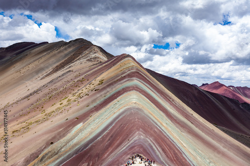 Close-up view of Rainbow Mountains Of Peru Peruvian Andes. Ausangate mountain. Bright colors and beautiful clouds. © anna1111986