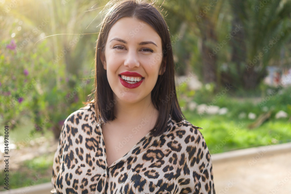 Young beautiful woman with red lips smiling happy at garden Young beautiful woman with red lips smiling happy at garden