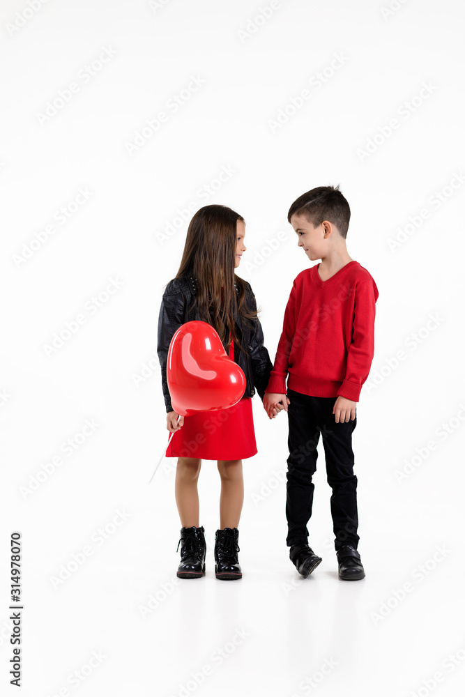 Happy kids with red heart balloon isolated on white background. St. Valentine's Day Happy kids with red heart balloon isolated on white background. St. Valentine's Day