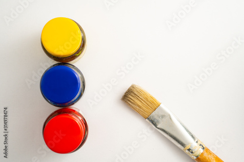 Obraz na plátně Top view of bottles of primary color on white background.