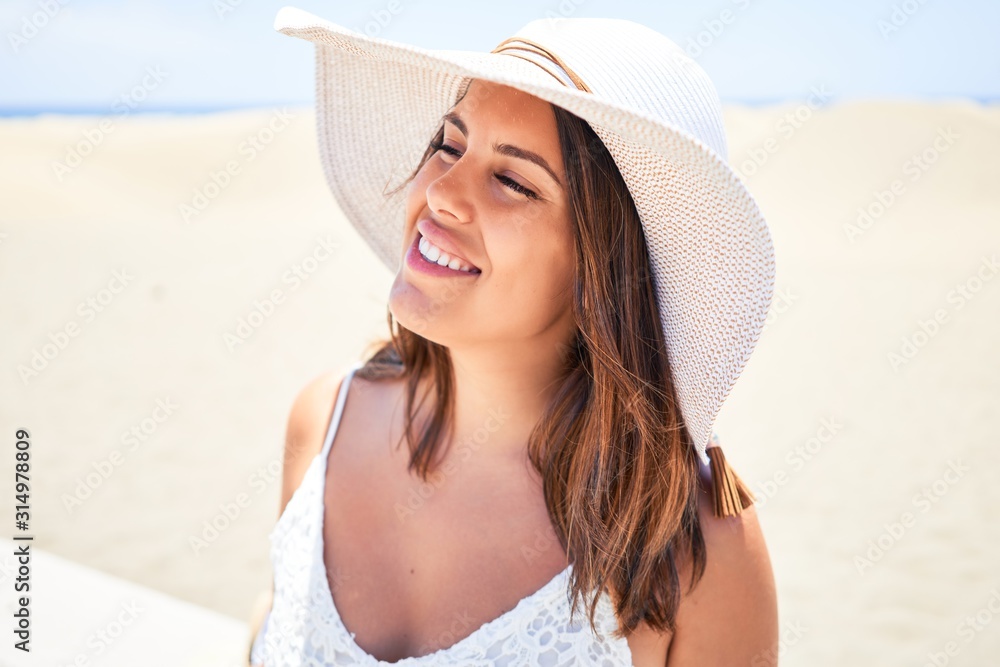 Young beautiful woman smiling happy enjoying summer vacation at maspalomas dunes beach