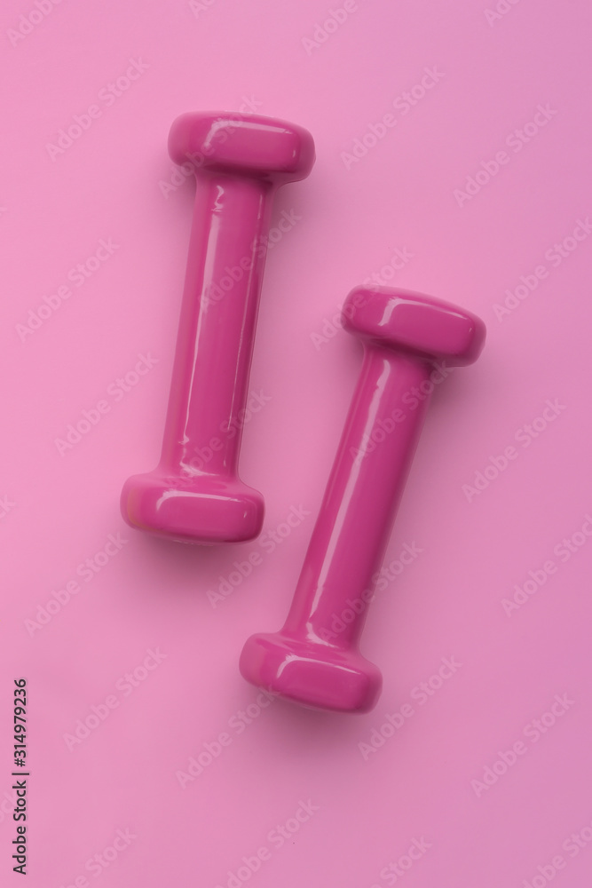 close up of dumbbell on pink background close up of dumbbell on pink background