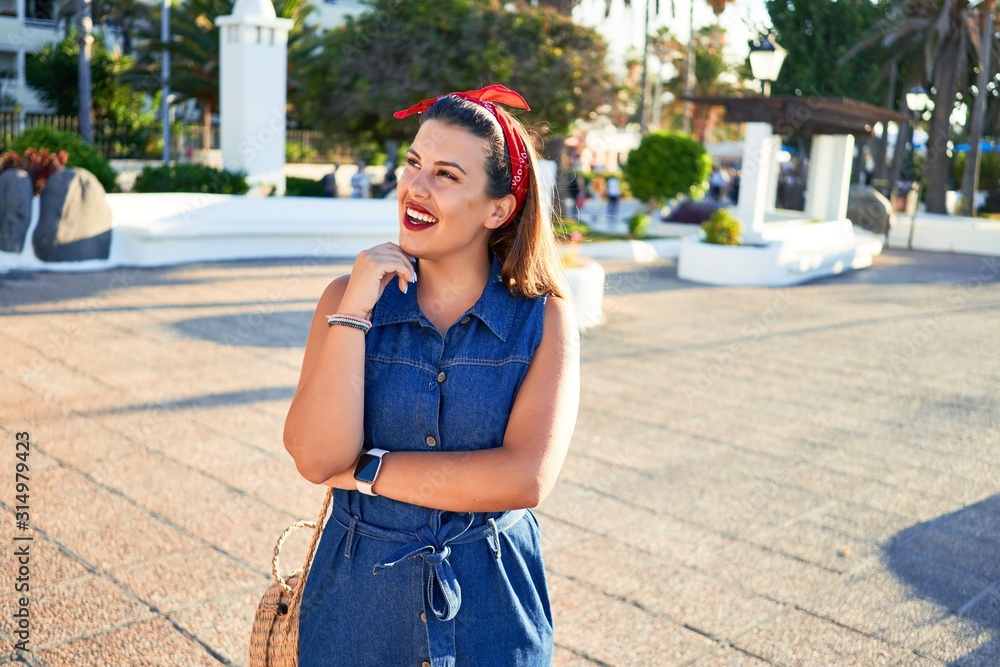Young beautiful woman smiling happy walking on city streets of Puerto de la Cruz, Tenerife on a sunny day of summer Young beautiful woman smiling happy walking on city streets of Puerto de la Cruz, Tenerife on a sunny day of summer