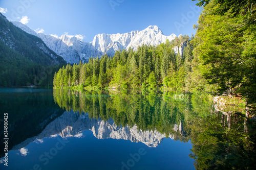 Fototapeta Naklejka Na Ścianę i Meble -  Beautiful morning scene with alpine peaks reflecting in tranquil mountain lake