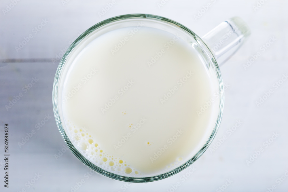 Glass of milk on wooden background. Top of view. Glass of milk on wooden background. Top of view.