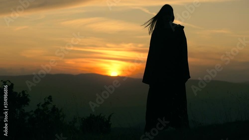 Fantasy dark wizard looking on sunset  photo