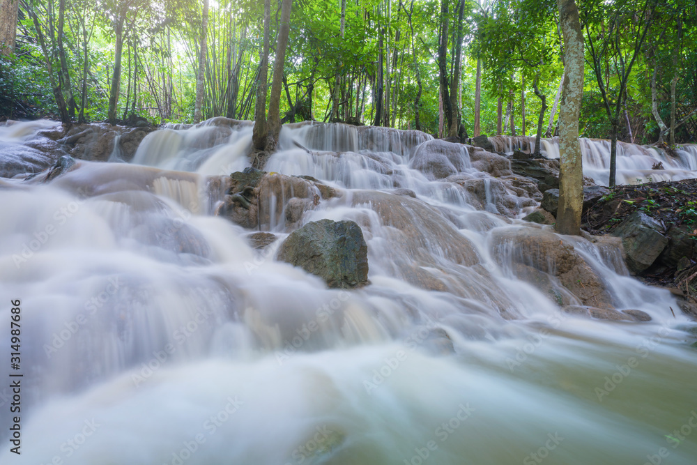 Waterfall scene at Pha Tad Waterfalls in rainforest at the Khuean Srinagarindra National Park Kanchanaburi.