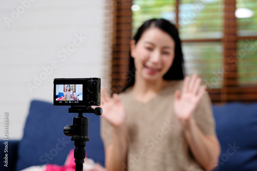 Asian blogger, Asia woman fashion blogger, influencer greeting while recording new content for vlog and fashion online shopping with camera at home studio, Freelance occupation, small business owner