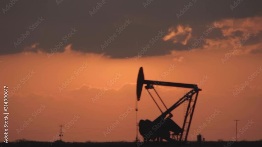 Solar Eclipse Time Lapse behind an oil industry pump jack. Solar Eclipse Time Lapse behind an oil industry pump jack.