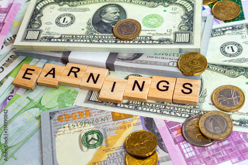 word text earnings on the money banknotes background
