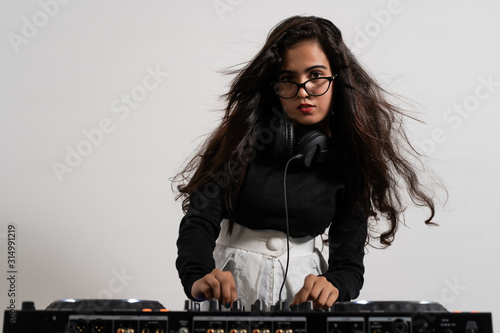 Beautiful DJ girl on decks on the party