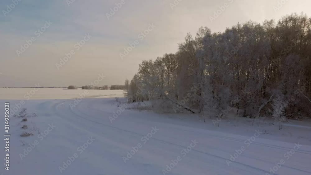 Aerial shot turn. Beautiful winter forest near snowy road