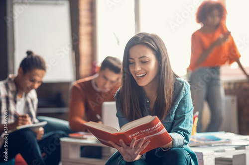 Beaming student feeling happy while studying foreign language