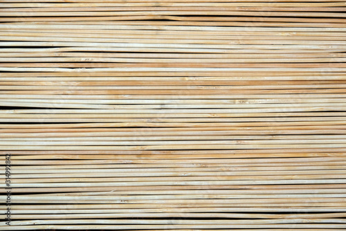 A fence made of thin light branches. Texture, background
