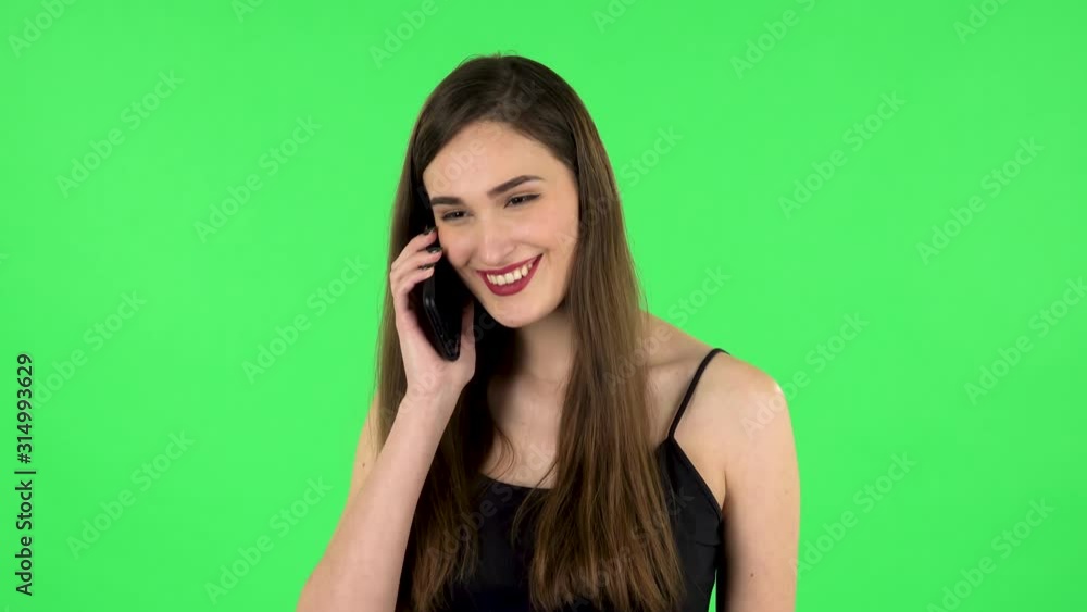 Smiling girl talking for mobile phone and rejoice. Green screen Smiling girl talking for mobile phone and rejoice. Green screen