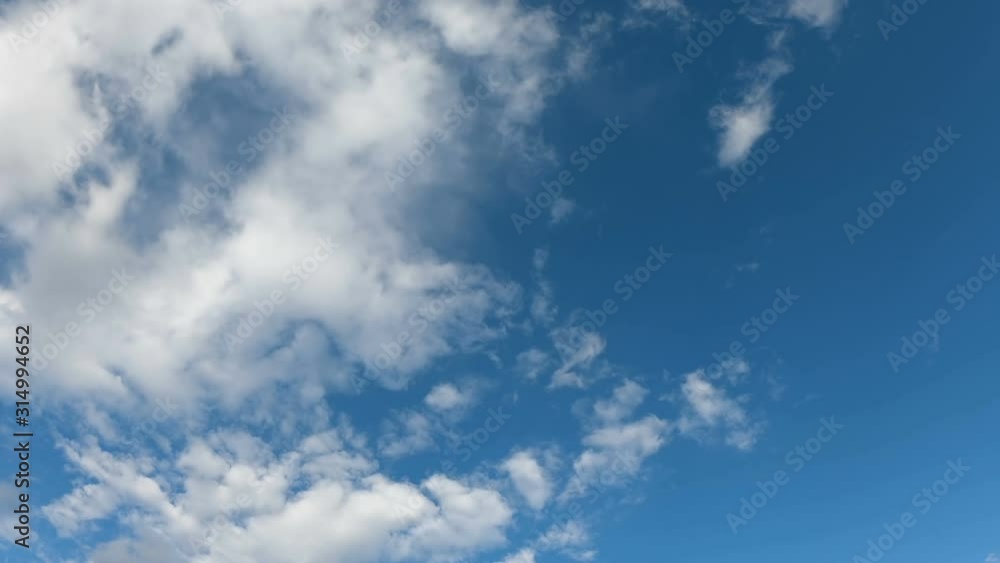 Timelapse of white fluffy clouds passing against blue sky Timelapse of white fluffy clouds passing against blue sky