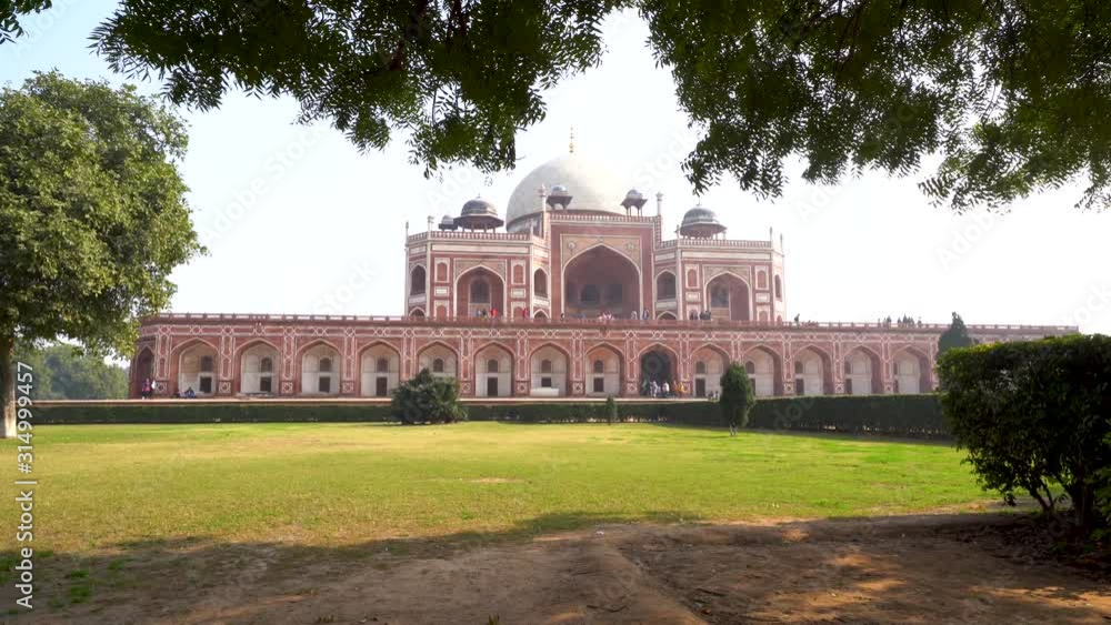 Humayan's Tomb ancient historical complex and ruins in New Delhi India. As seen with reflecting pond on a clear sunny day Humayan's Tomb ancient historical complex and ruins in New Delhi India. As seen with reflecting pond on a clear sunny day