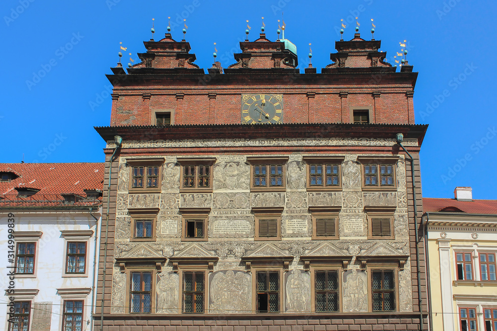 View of Renaissance Pilsen Town Hall,  built in 1558. The building is decorated with sgrafitto depicting the heads of the Bohemian estates and Pilsen’s coat of arms.