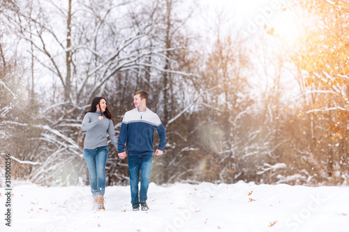 wedding engagement Concept. people, season love and leisure concept. happy couple walking through the park on a snowy day. Romantic couple in love feeling happiness romance Valentine . love copy space