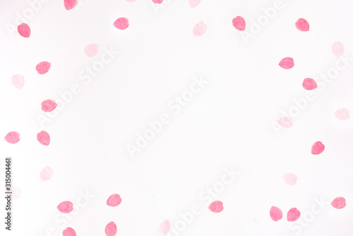 Valentine's day background with scattered paper pink rose petals on a white background © Sunshine