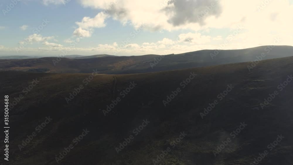 Aerial flying over epic landscape mountains with roads on it in ireland Aerial flying over epic landscape mountains with roads on it in ireland