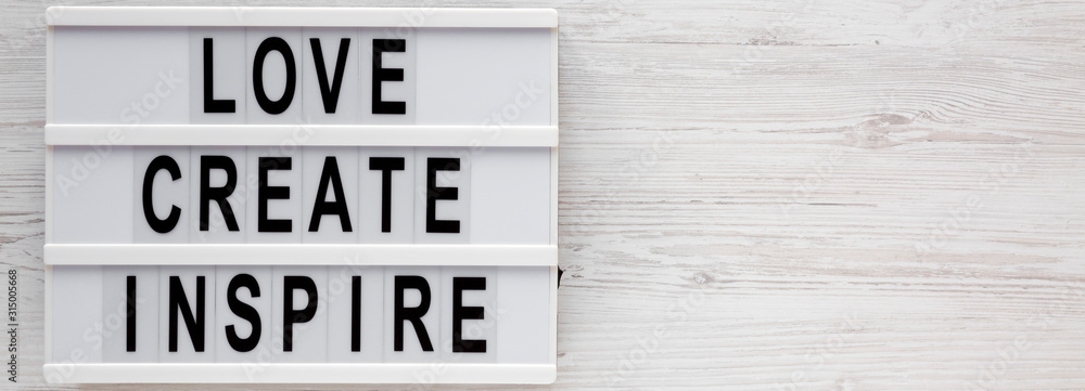 'Love create inspire' words on a lightbox on a white wooden background, top view. Overhead, from above, flat lay. Copy space. 'Love create inspire' words on a lightbox on a white wooden background, top view. Overhead, from above, flat lay. Copy space.