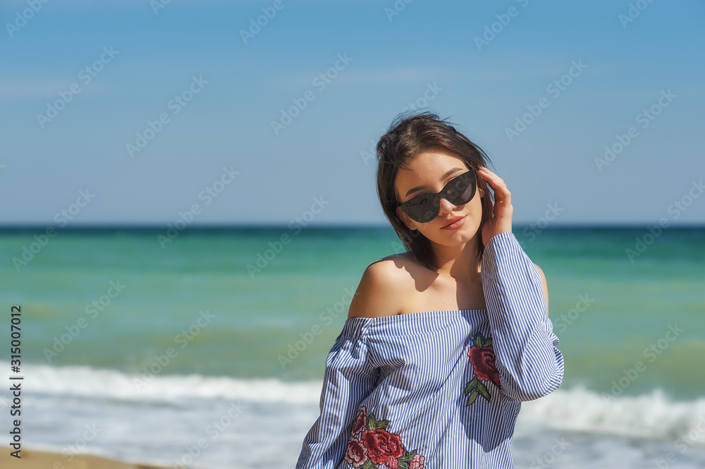 Portrait of a young girl resting on the sea coast
