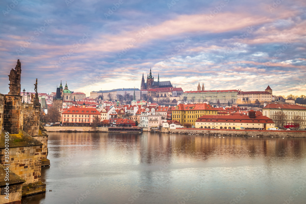 Prague Castle and Charles bridge above Vltava river early morning with beautiful sky, Czech Republic, Europe.