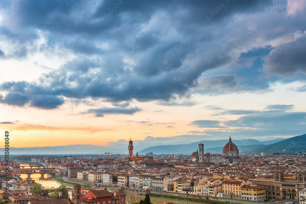 Amazing panoramic sunset view of Florence city, Italy with the river Arno, Ponte Vecchio, Palazzo Vecchio and Cathedral of Santa Maria del Fiore.