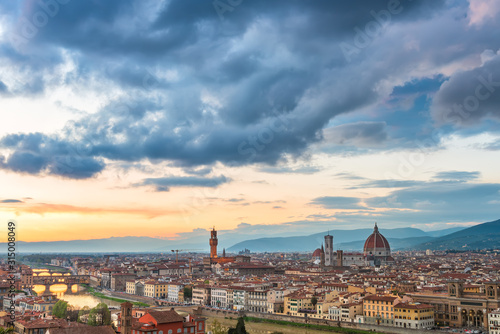 Amazing panoramic sunset view of Florence city, Italy with the river Arno, Ponte Vecchio, Palazzo Vecchio and Cathedral of Santa Maria del Fiore.