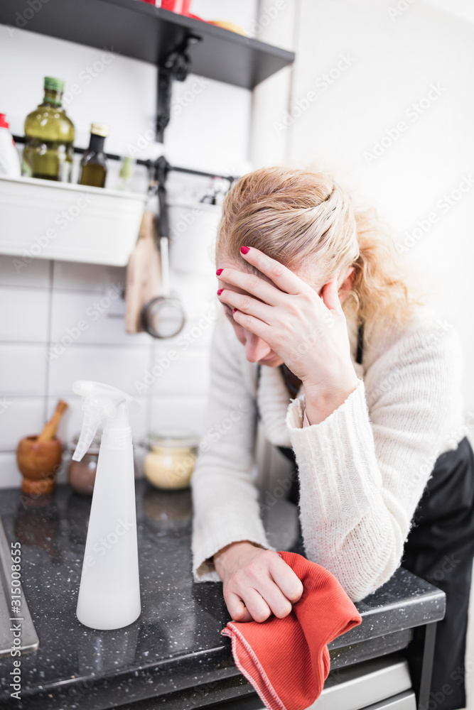 Woman tired from cleaning the house, kitchen and doing daily housework. Woman tired from cleaning the house, kitchen and doing daily housework.