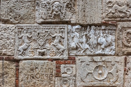 Аntique stone plates from Etruscans and the Romans built into the wall of a building in Montepulciano, Italy