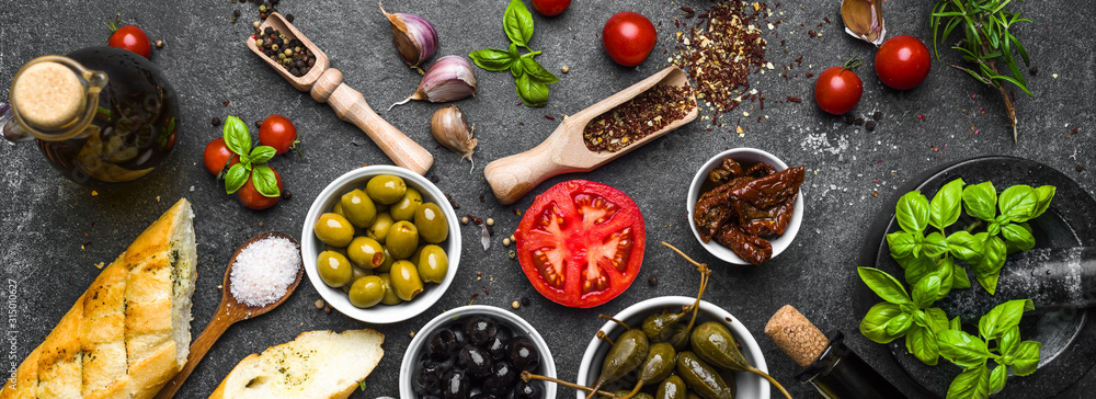 Mediterranean food background. Cooking ingredients on dark stone. - obrazy, fototapety, plakaty 