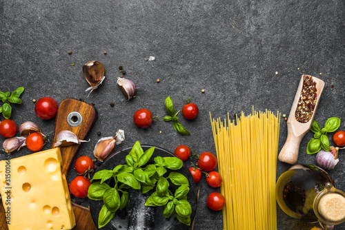 Italian food ingredients of spaghetti bolognese: tomatoes, pasta, basil, cheese and spices