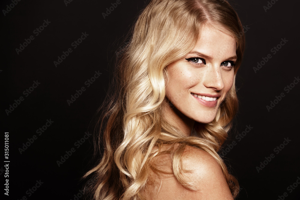 close-up portrait of smiling young woman with curly blond hair close-up portrait of smiling young woman with curly blond hair