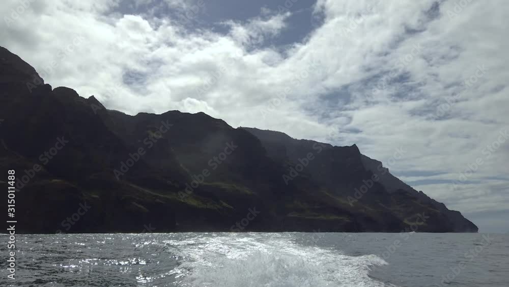HD Hawaii Kauai Boating on the ocean view of wake and steep shoreline HD Hawaii Kauai Boating on the ocean view of wake and steep shoreline