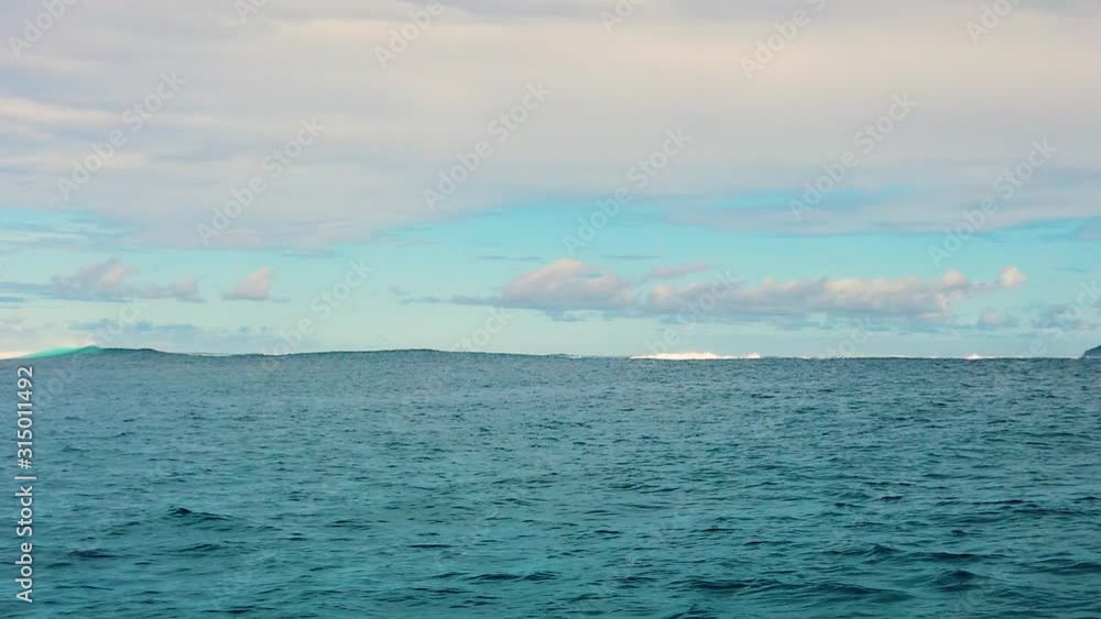 HD 120fps Hawaii Kauai Boating on the ocean floating left to right nice wave cresting and crashing in distance