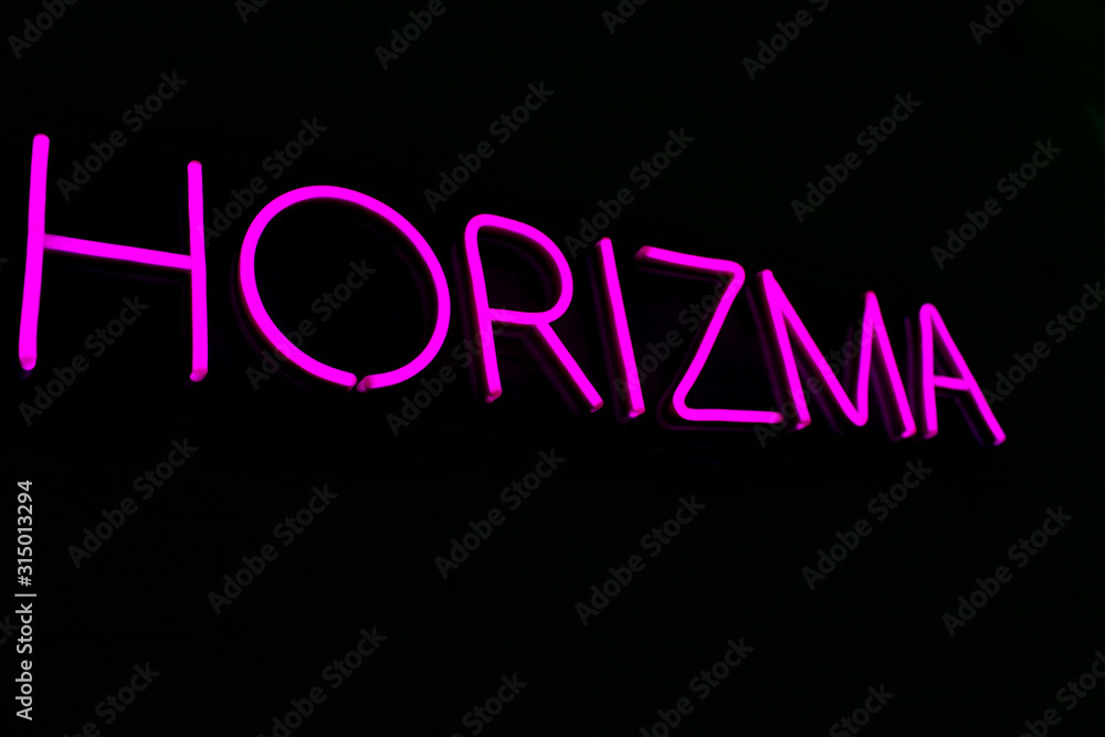 Glowing neon sign on isolated black background. Horizma neon sign. Charisma. Neon concept. Trendy style. 